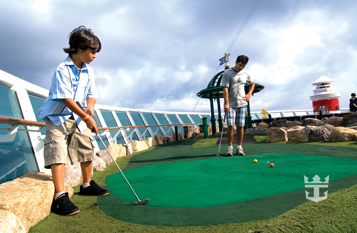 View of father and son playing mini deck onboard Voyager of the Seas